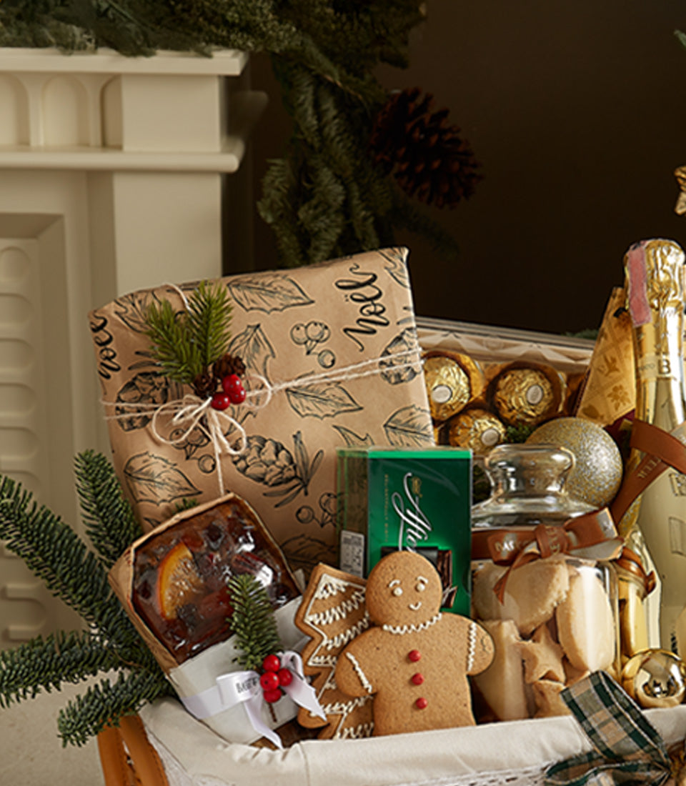 Golden Celebration Christmas hamper with prosecco, fruitcake, gingerbread, and festive treats in white basket