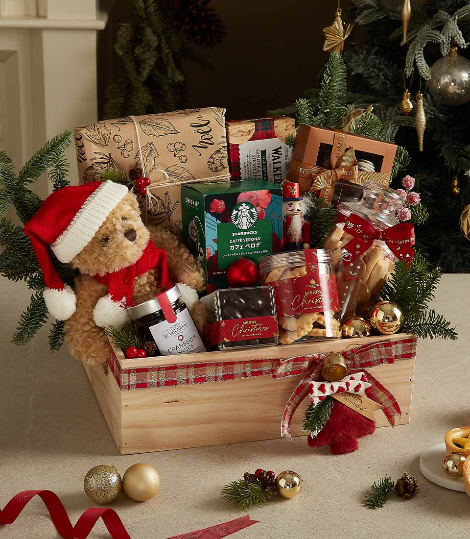 Festive wooden Christmas gift crate with plaid ribbon, Santa teddy bear, gourmet treats, and holiday decorations