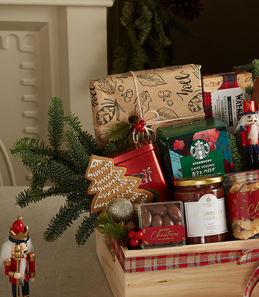Festive wooden Christmas gift crate with gourmet treats, gingerbread, shortbread, coffee, and holiday decorations