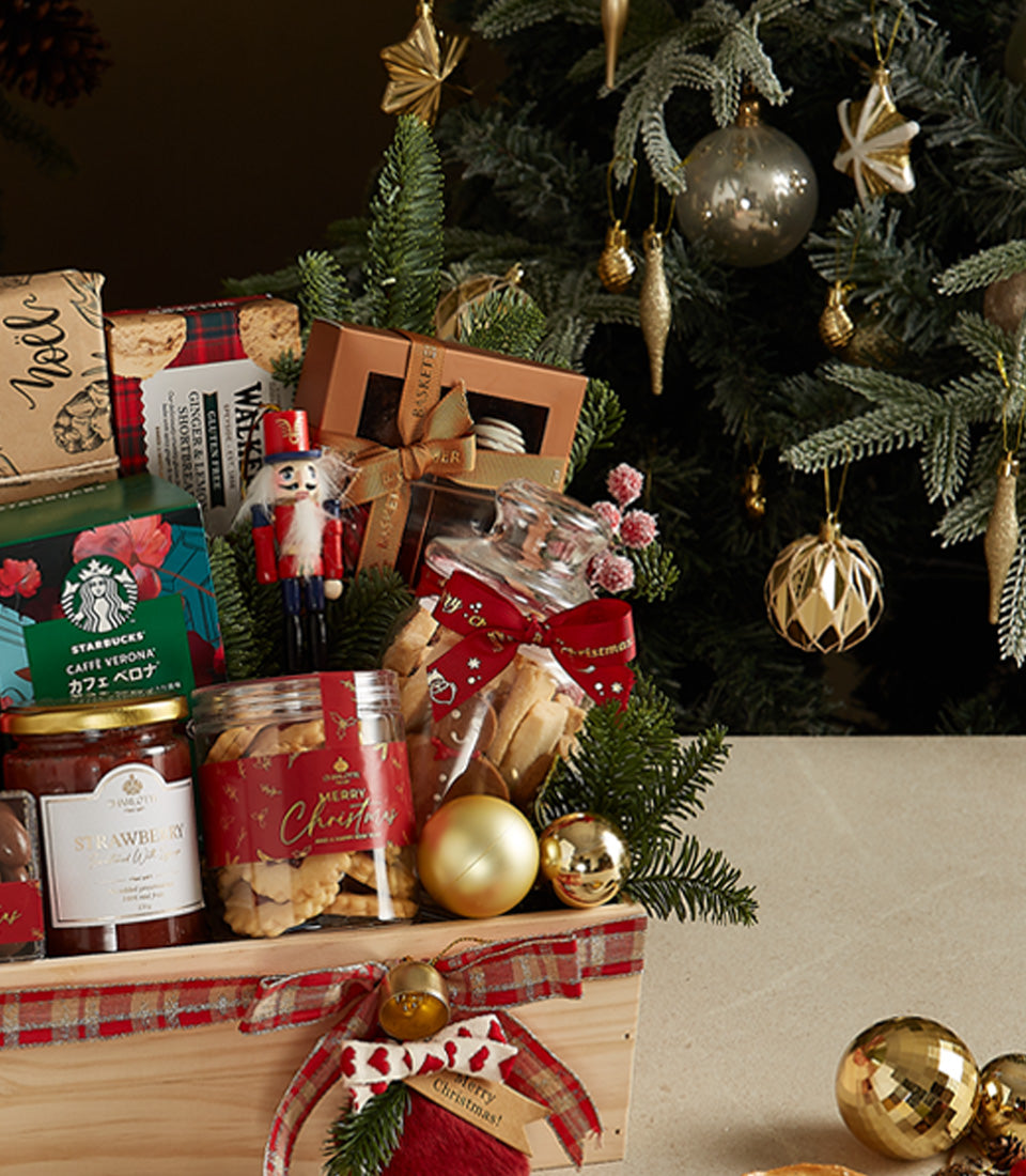 Festive Christmas gift crate with gourmet treats, strawberry jam, shortbread, coffee, and holiday decorations