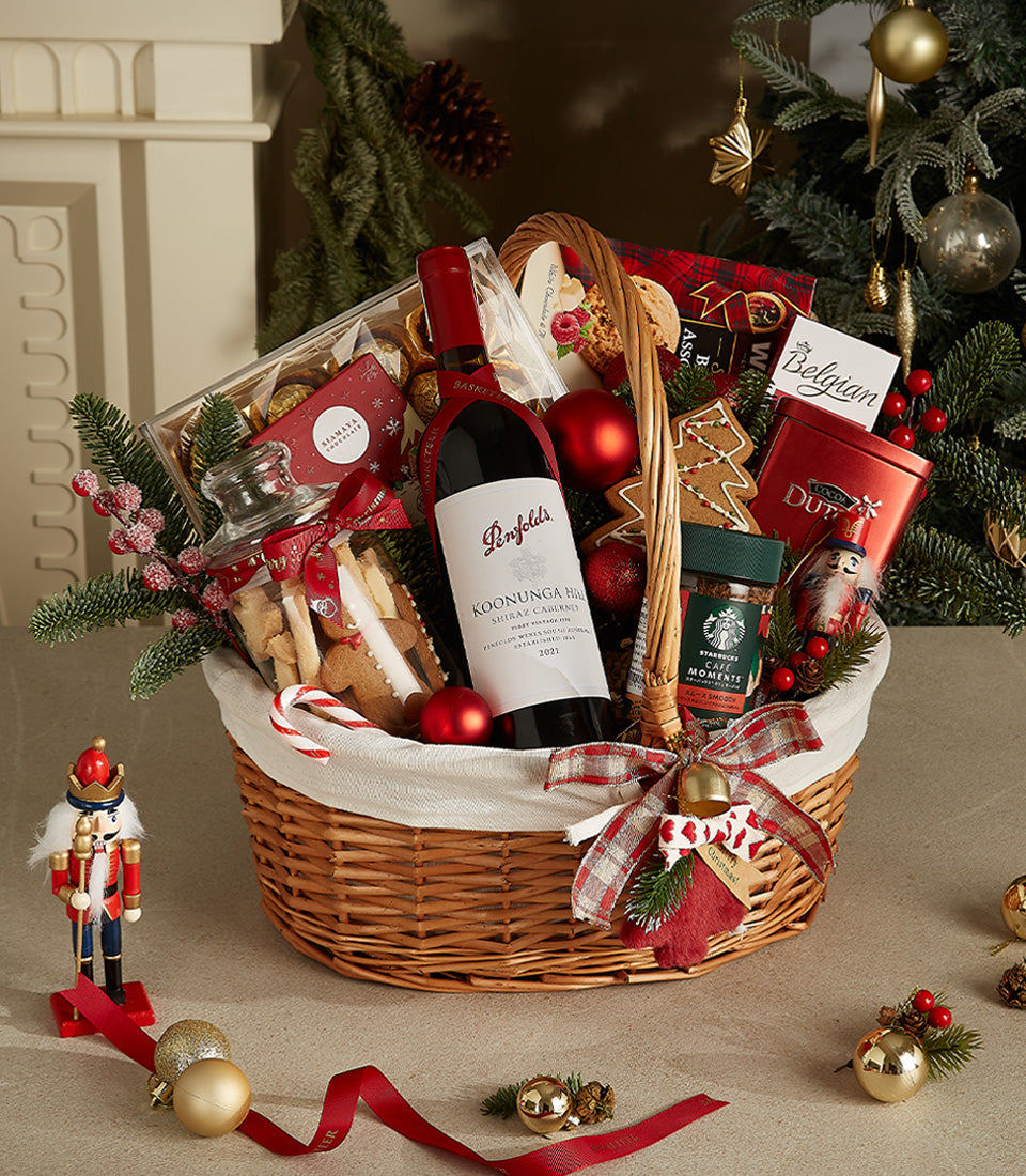 Luxury red wine Christmas gift basket with gourmet chocolates, cookies, and festive wicker presentation