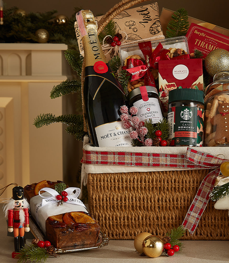 Luxury Christmas hamper with Moët & Chandon champagne, gourmet chocolates, cranberry sauce, gingerbread cookies, and festive