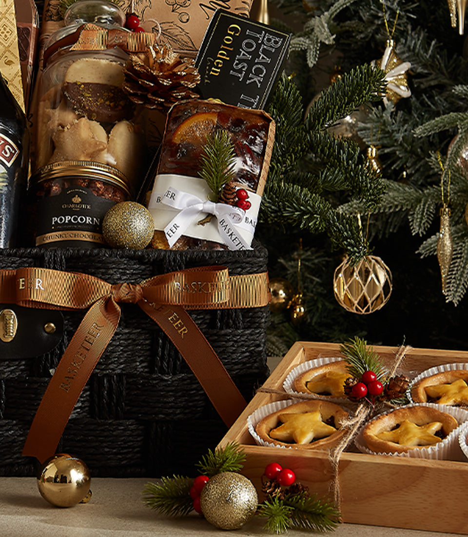Premium black Christmas hamper with cookies, chocolate popcorn, fruitcake, and gourmet pastries, festive holiday gift basket