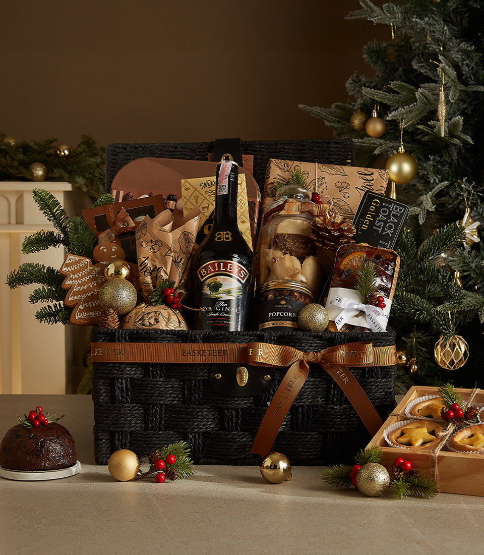 Luxury black woven Christmas hamper with Baileys, gourmet treats, and festive baked goods