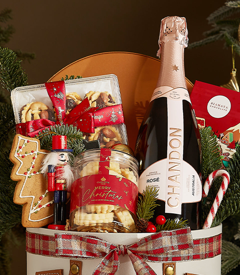 Festive Chandon Rosé champagne hamper with shortbread, mixed nuts, gingerbread and festive red plaid ribbon