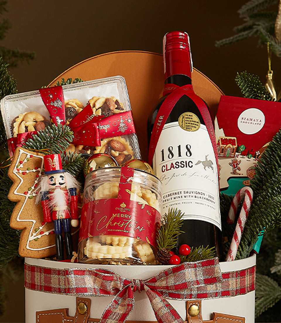 Elegant 1818 Cabernet Sauvignon Christmas gift basket with premium chocolates, shortbread, and festive treats