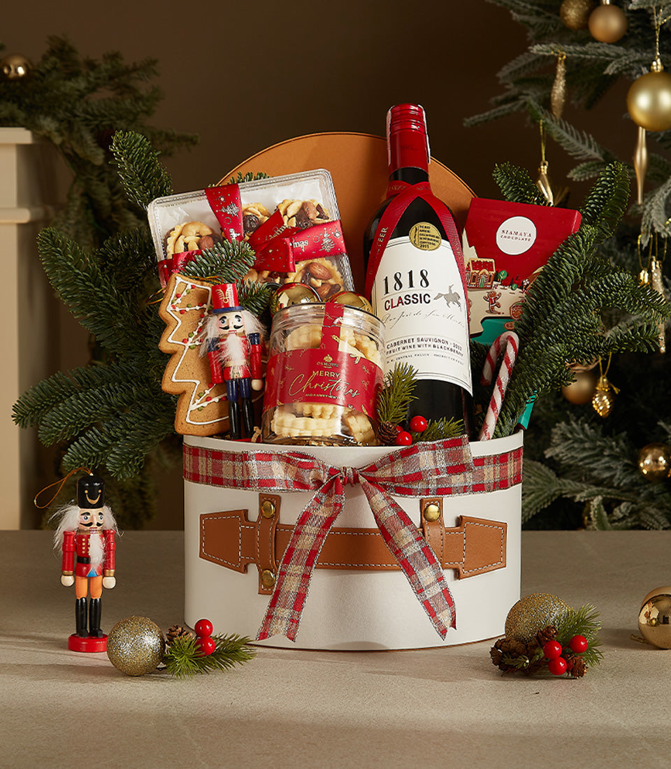 Elegant 1818 Classic red wine Christmas gift basket with nuts, shortbread, and holiday ornaments
