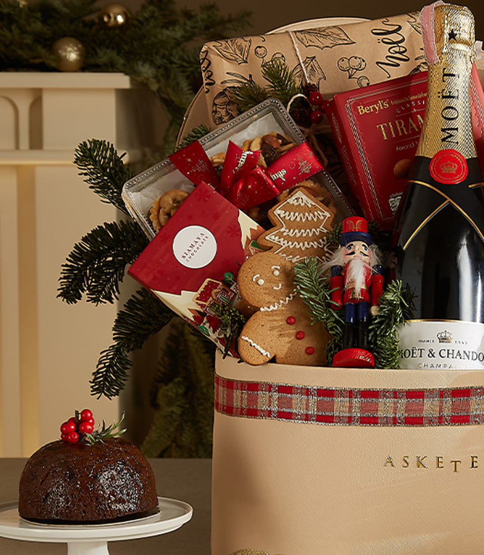 Luxury champagne and gourmet Christmas gift basket with Moët & Chandon, festive treats, and artisan pudding
