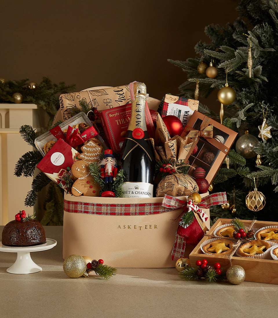 Luxury champagne Christmas hamper with gourmet chocolates, shortbread, and festive treats in beige leather basket