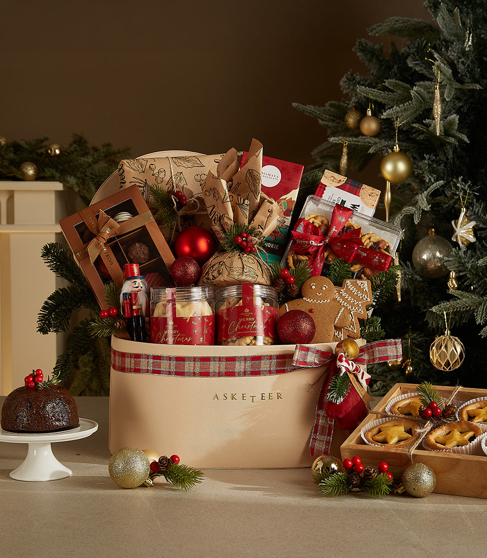 Deluxe Christmas gourmet hamper with chocolates, cookies, and festive treats in beige leather box with plaid ribbon