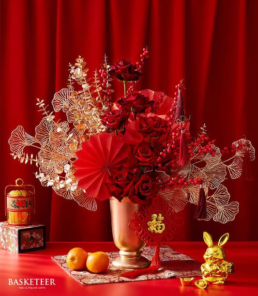 Harmony Lunar Flower Vase with deep red roses, gold ginkgo leaves, and festive Chinese New Year décor in golden accents