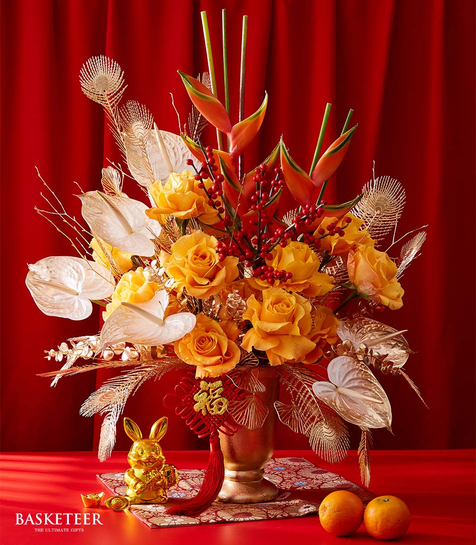 Premium imported roses with white anthuriums, red berries, and gold accents in festive Chinese New Year arrangement