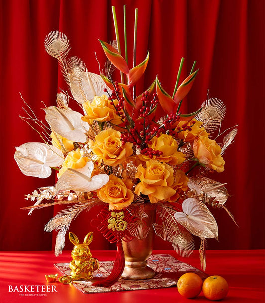 Premium imported roses with white anthuriums, red berries, and gold accents in festive Chinese New Year arrangement