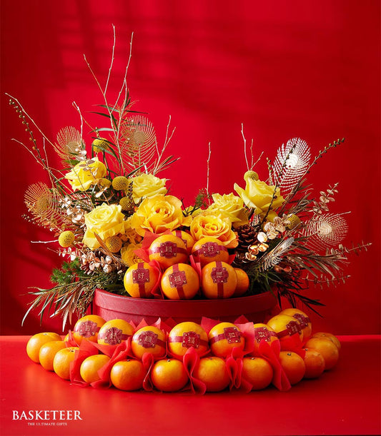 Golden Bloom Mandarin gift box with yellow roses, golden feathers, and red-ribboned tangerines for Chinese New Year