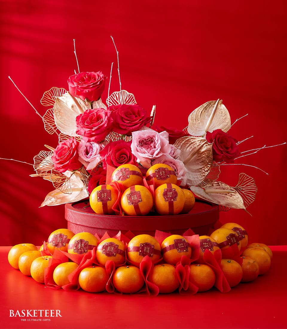 Blooming Prosperity red gift box with fresh roses, gold foliage, and ribbon-wrapped mandarins for Chinese New Year