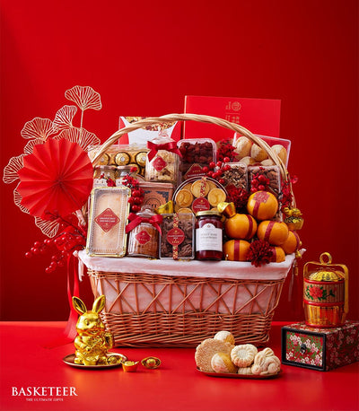 Festive Chinese New Year luxury gift basket with gourmet treats, fresh oranges, artisan cakes, and golden prosperity symbols