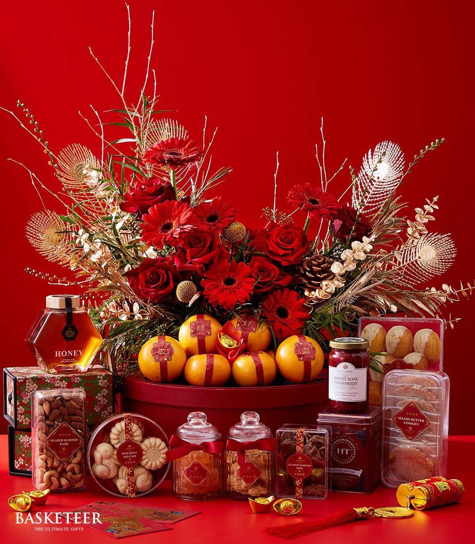 Premium red rose and gerbera floral gift set with lucky oranges, honey, nuts, and festive sweets for Chinese New Year