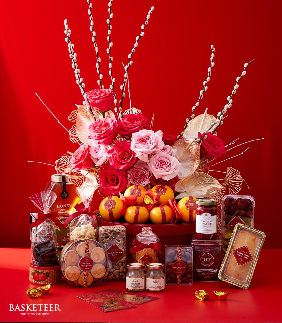 Luxury Chinese New Year gift hamper with red roses, gold accents, tangerines, honey, jam, pound cake, and festive treats