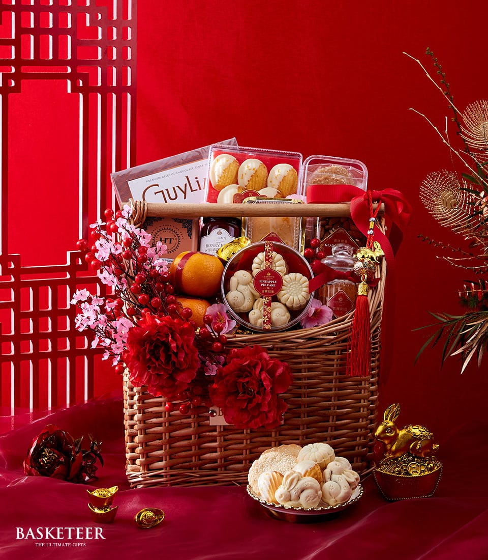 Royal Mandarin Sweets festive gift basket with pineapple pies, cookies, honey, fresh oranges, and red peonies for Chinese