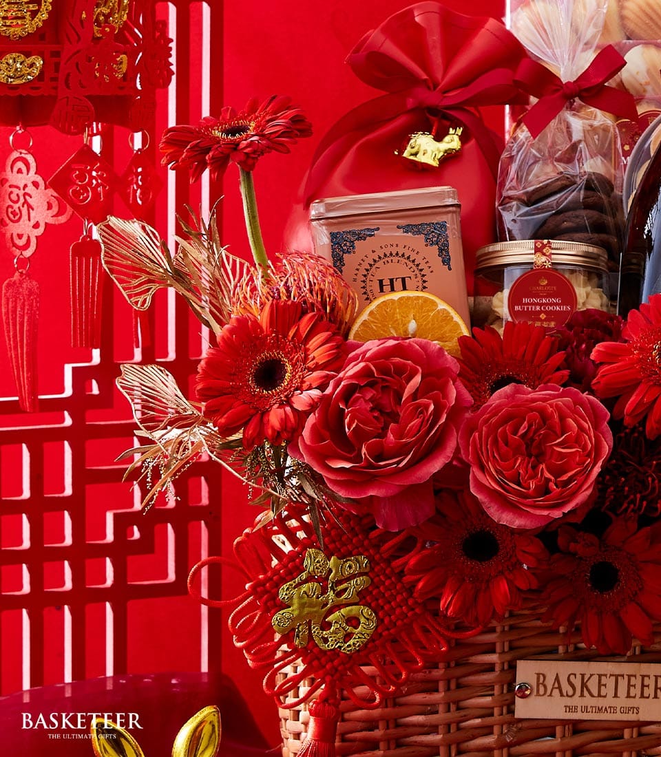 Prosperity Luxe Lunar Year red and gold gift basket with roses, gerberas, premium tea, butter cookies, and festive charms