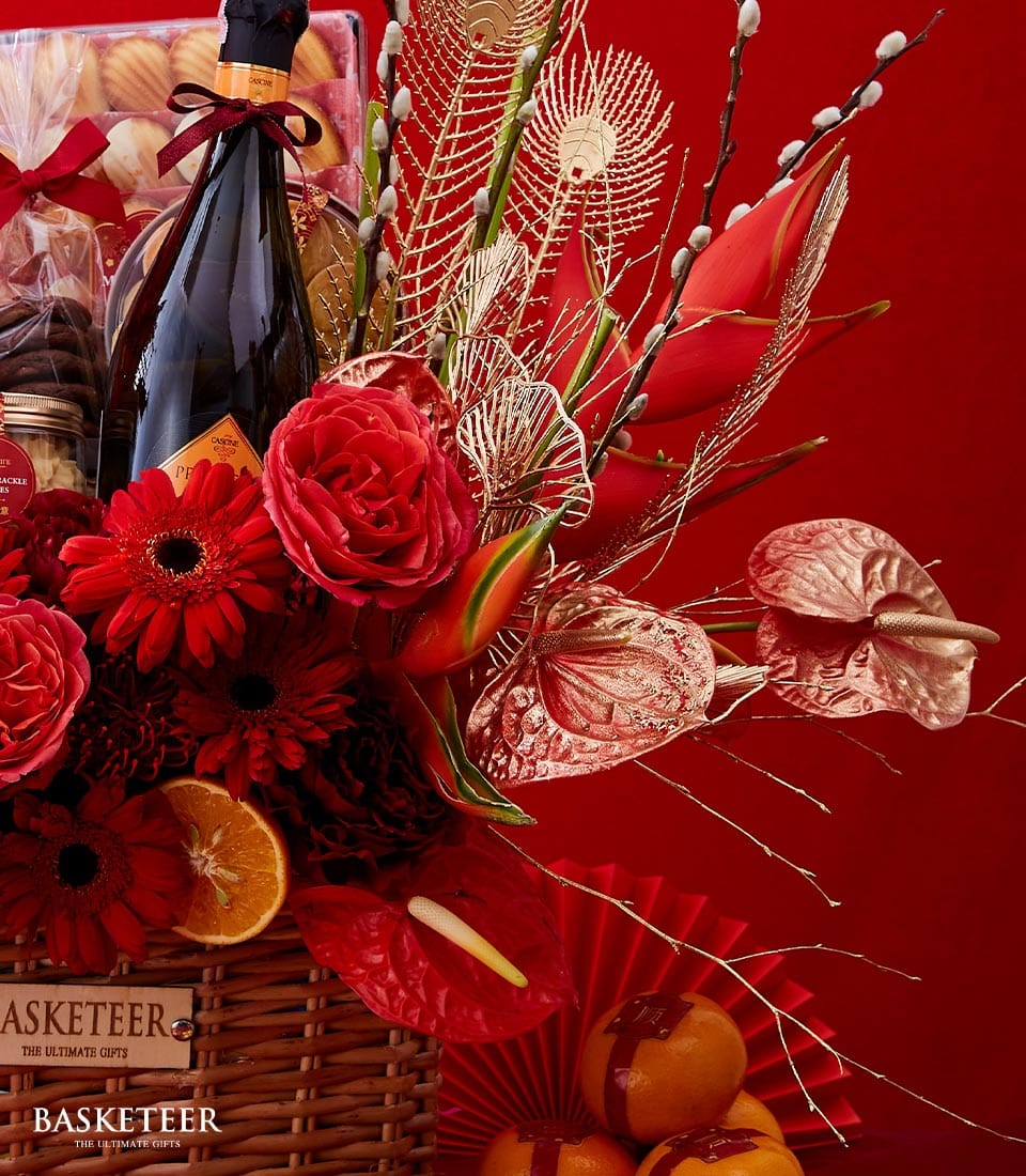 Luxury red and gold Lunar Year gift basket with champagne, roses, gerbera daisies, and artisan baked goods