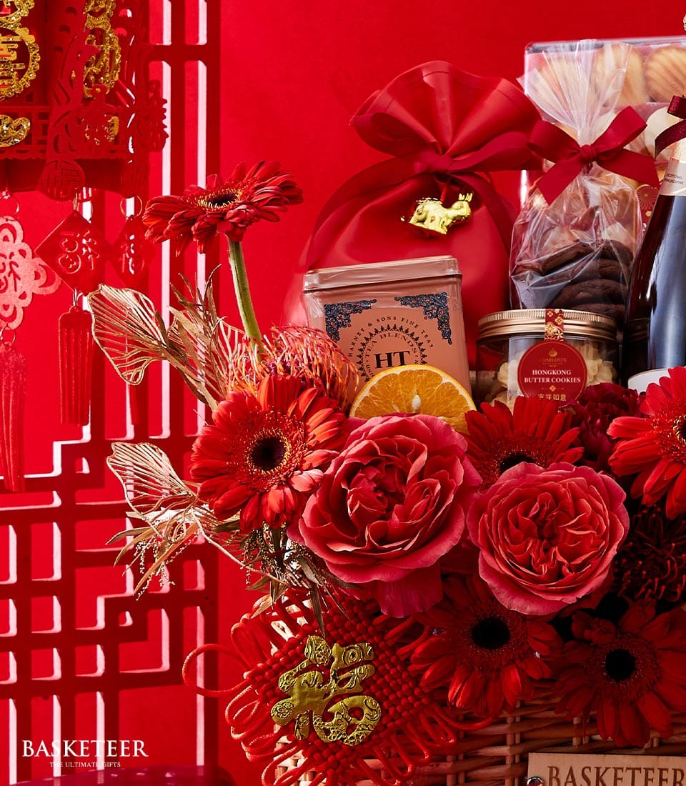 Red luxury Chinese New Year gift basket with premium wine, fine teas, butter cookies, and festive roses