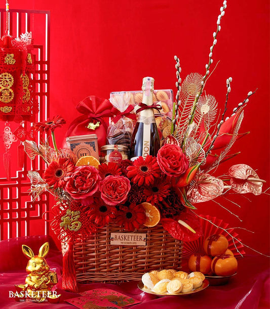 Luxury Chinese New Year gift basket with sparkling wine, red roses, gerbera daisies, gourmet treats, and gold accents