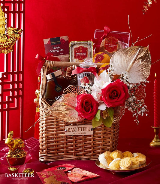 Elegant Chinese New Year gift hamper with roses, oolong tea, pound cake, and sesame cookies in woven basket