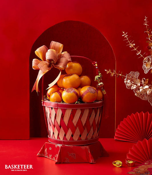 Luxury mandarin orange gift basket with red woven design, gold ribbon, and Lunar New Year prosperity charms