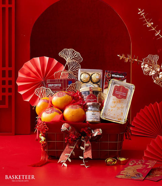 Red and gold festive hamper with lucky oranges, almond cookies, pound cake, and drip coffee for Lunar New Year