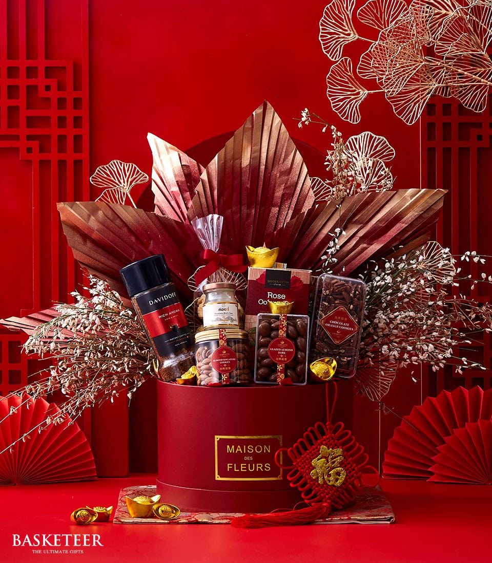 Luxury Chinese New Year gift hamper with premium spirits, gourmet nuts, chocolates, and festive red-gold décor