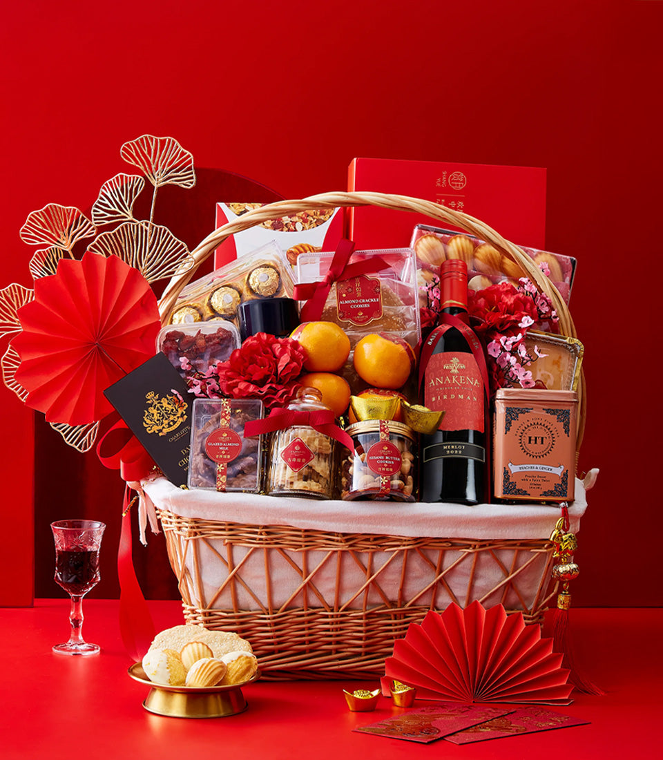 Luxury wicker basket with red wine, oranges, chocolates, and nuts for Chinese New Year gifting