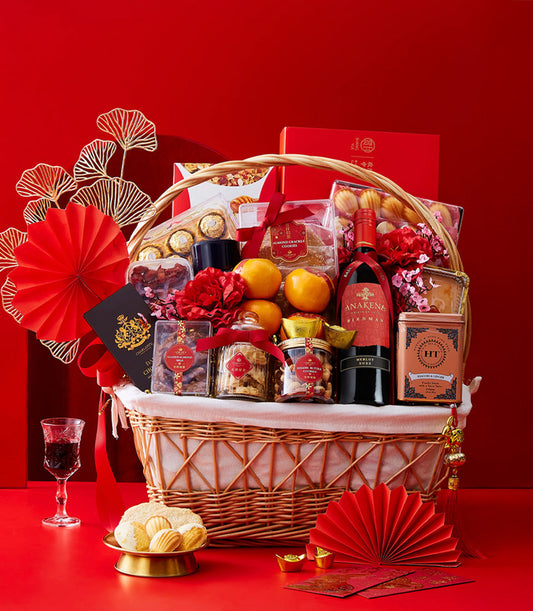 Luxury wicker basket with red wine, oranges, chocolates, and nuts for Chinese New Year gifting