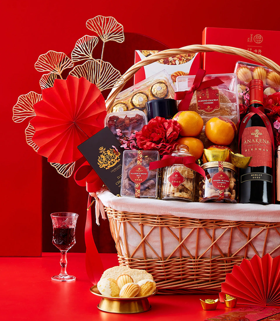 Premium red wine and gourmet gift basket for Chinese New Year celebrations with merlot, artisan cookies, and lucky gold