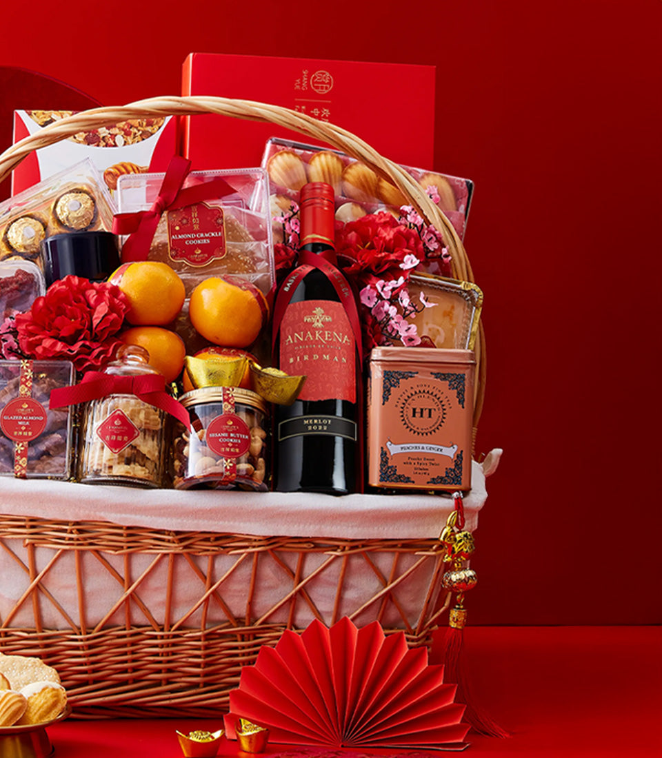 Luxury Chinese New Year gift basket with red wine, mandarins, artisan cookies, and festive gold accents