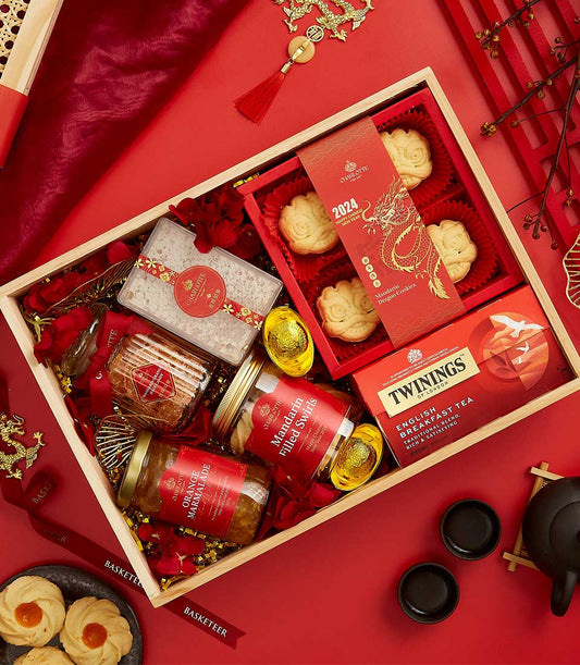 Divine Chinese New Year luxury gift box with cookies, marmalade, tea, and golden accents on red background
