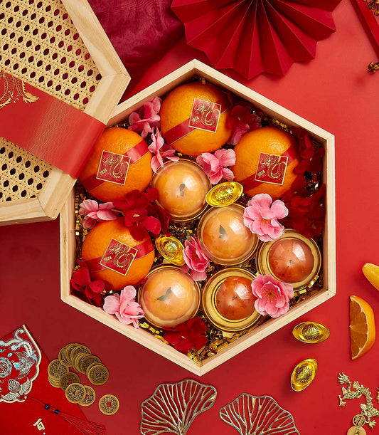 Basketeer premium hamper for CNY, featuring mandarin oranges and lucky sweets in a wooden gift box with red ribbon. Perfect luxury gift basket Bangkok.