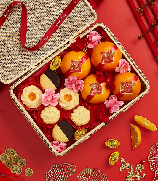 Basketeer CNY gift. Wicker hamper with Lunar New Year mandarin oranges, festive cookies, and gold ingots. Premium hamper delivery in Thailand.