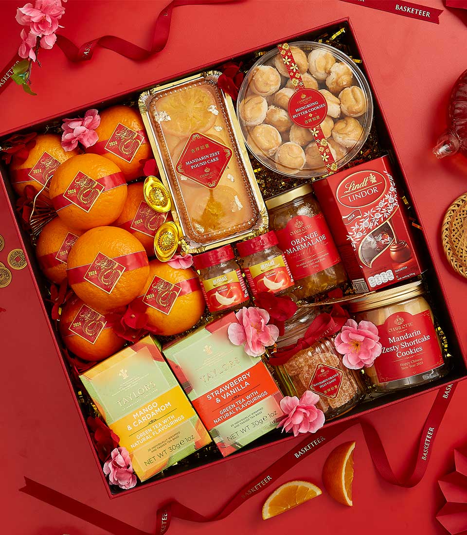 Red and gold Chinese New Year gift box with lucky oranges, mandarin pound cake, butter cookies, chocolates, marmalade, and