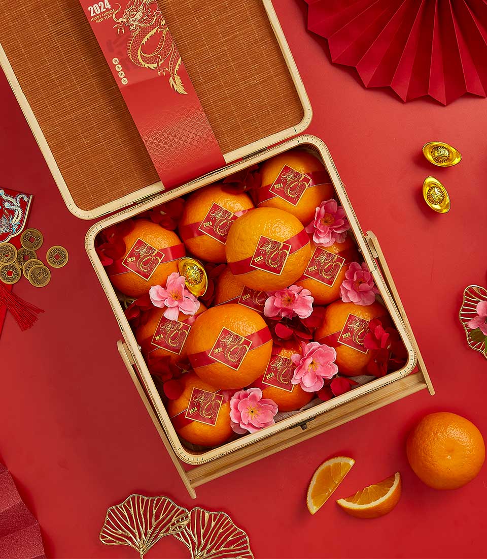 Mandarin Blessings gift basket with fresh oranges, red ribbons, and golden dragon labels for Chinese New Year