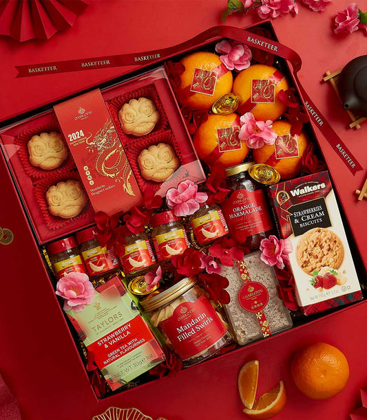 Luxury red CNY gift box with mandarin oranges, artisan cookies, marmalade, and premium baked goods for Chinese New Year