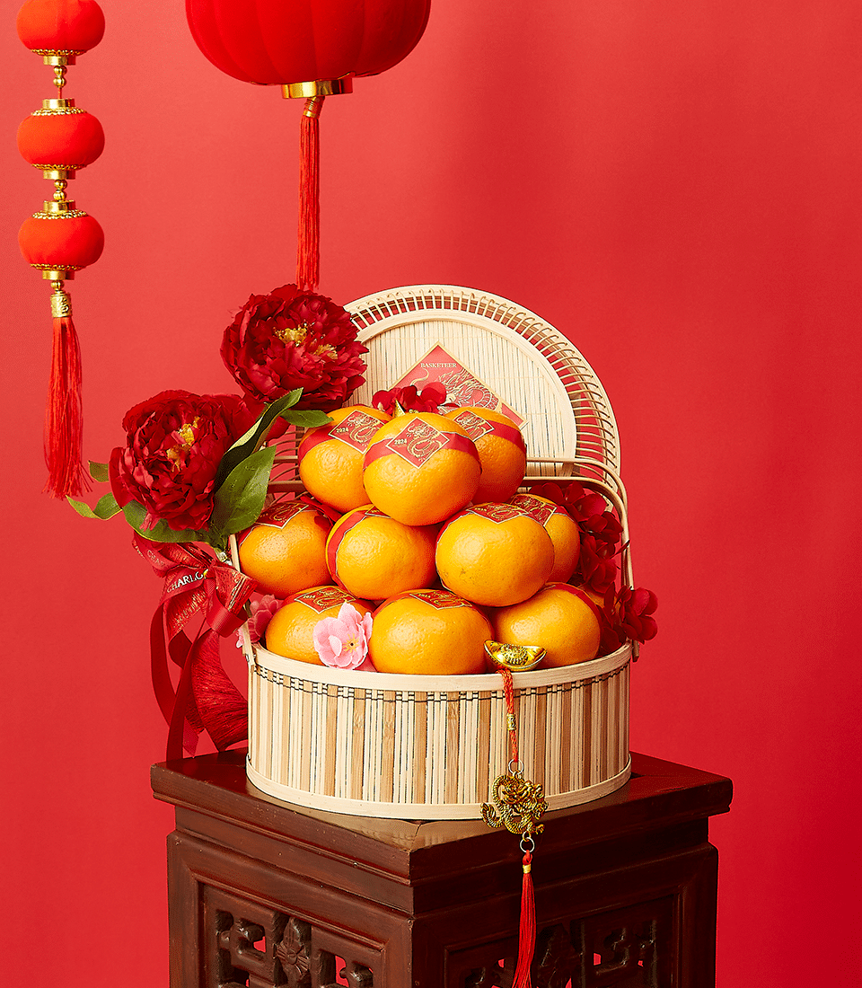 Imperial Mandarin Elegance bamboo basket with red-banded 2024 oranges, red peonies, and gold ingot charm for Chinese New Year