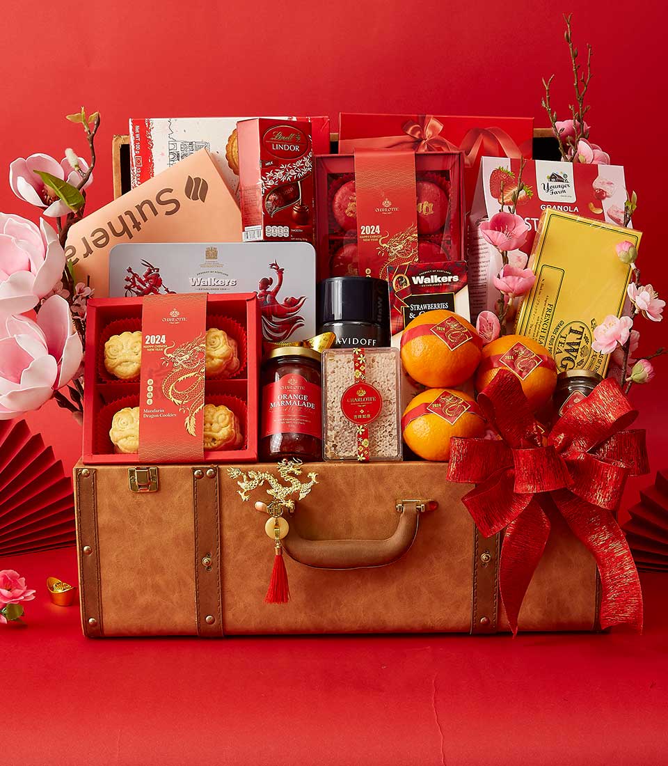 Luxury Chinese New Year hamper in brown leather suitcase with gold dragon charm, filled with premium gourmet treats, teas,