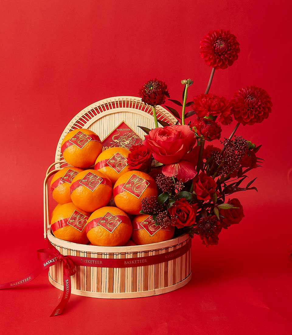 Red and gold Chinese New Year basket with mandarins and roses, dragon-labeled fruit, festive bloom arrangement