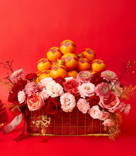 Mandarin Bliss celebration basket with fresh roses, carnations, and chrysanthemums stacked with lucky mandarins and gold