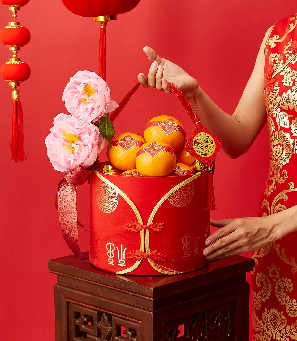 Citrus Wonders CNY gift basket with red qipao-style box, fresh mandarin oranges, gold ingots, and peony flowers for Chinese