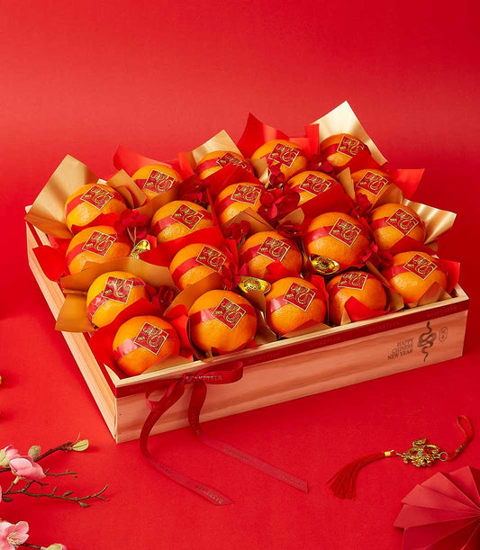 Prosperity Mandarin wooden crate with ribbon-wrapped oranges, gold dragon charms, and Chinese New Year decorations