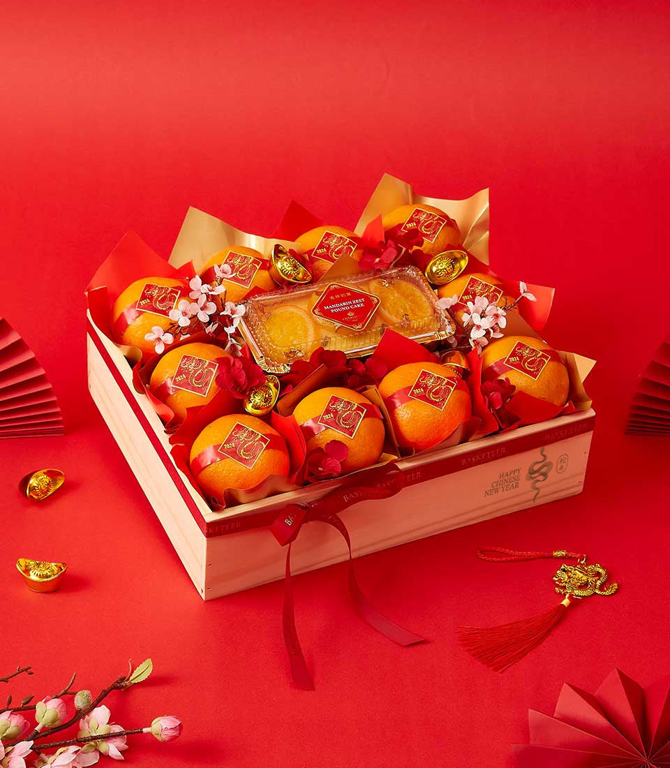 Festive Chinese New Year gift box with mandarins, mandarin zest pound cake, and red gold dragon accents
