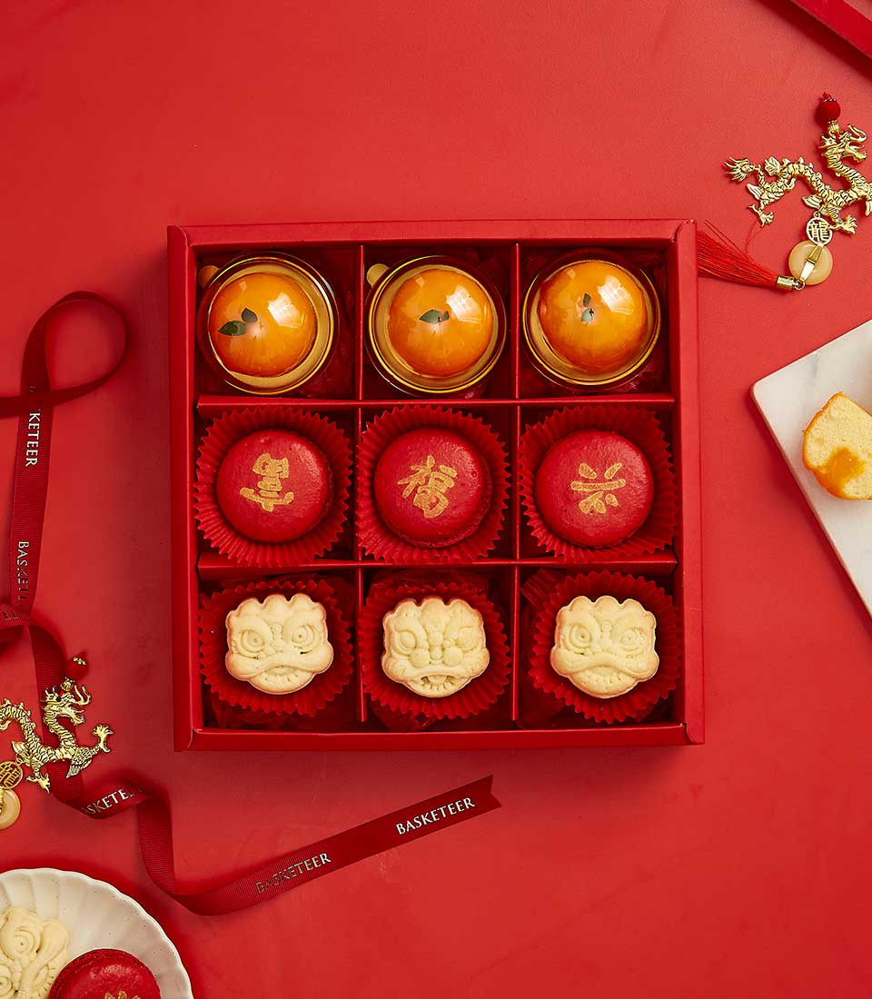 Red CNY gift box with nine handcrafted pastries, mooncakes, and lion-head cookies with gold dragon charms