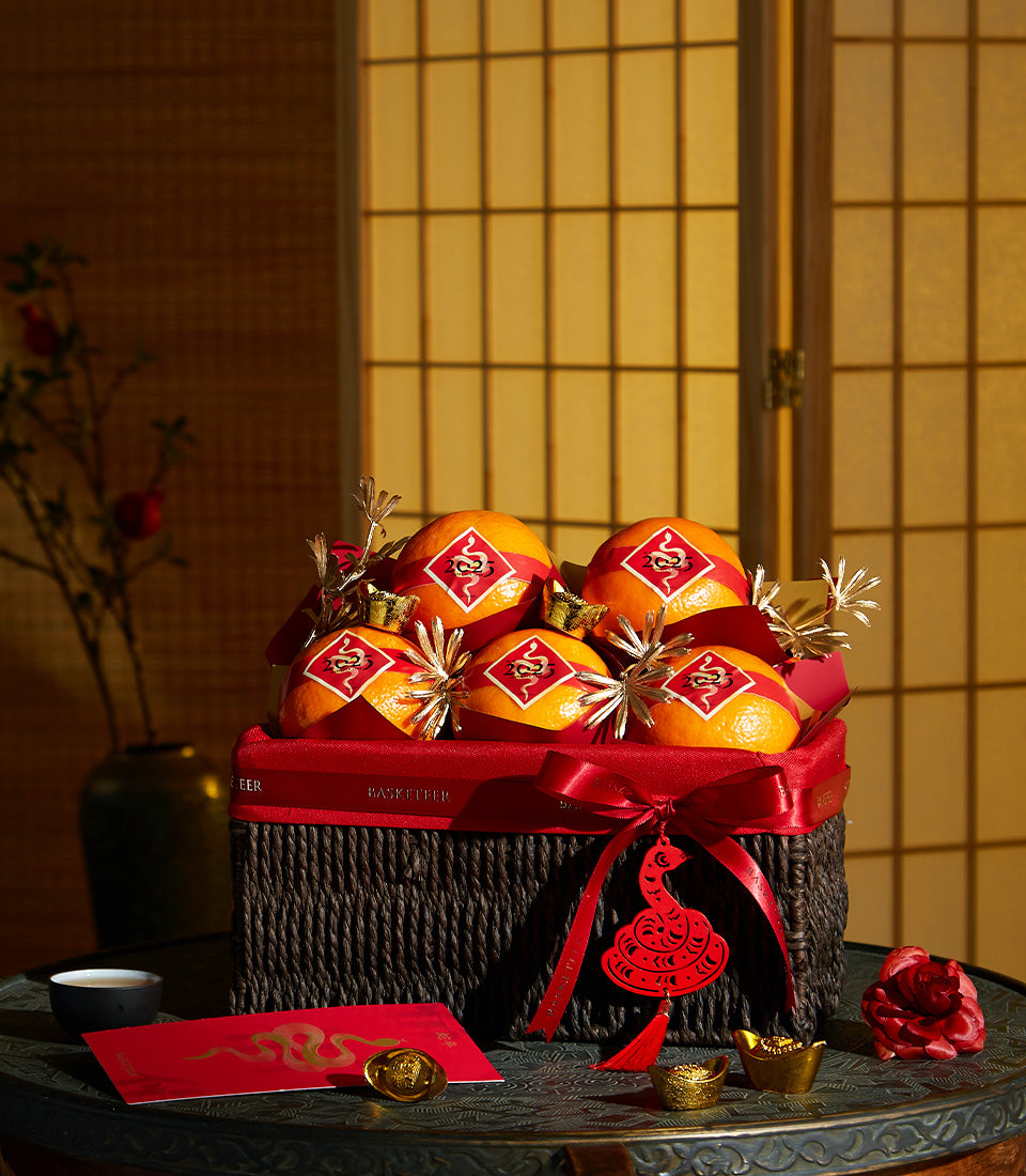 Basketeer luxury gift basket Bangkok filled with festive oranges and gold accents for Chinese New Year. Premium hamper delivery Thailand.